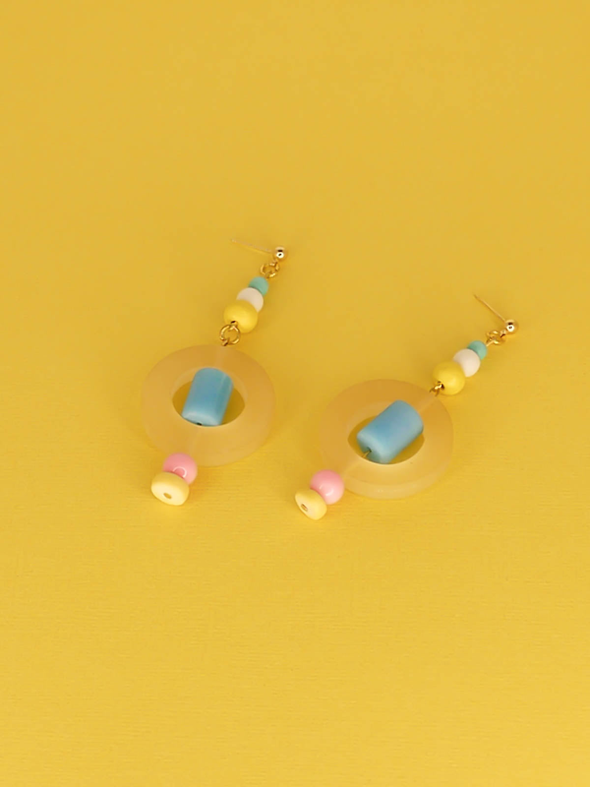 Colourful lightweight hoop bead earrings with glass & wood beads in yellow, pink & turquoise with a resin yellow hoop in the centre & a resin blue tube bead in the middle. Hung from 24k gold plated ball studs.